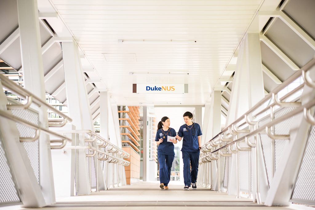 Two Duke NUS medical students walk across a bridge on campus